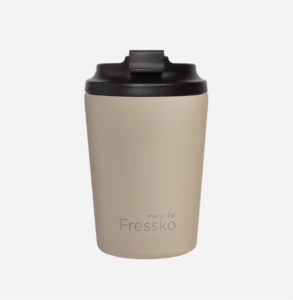Stainless steal reusable coffee cup in oat colour with black lid.